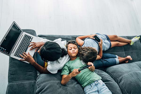 Mother and children on devices